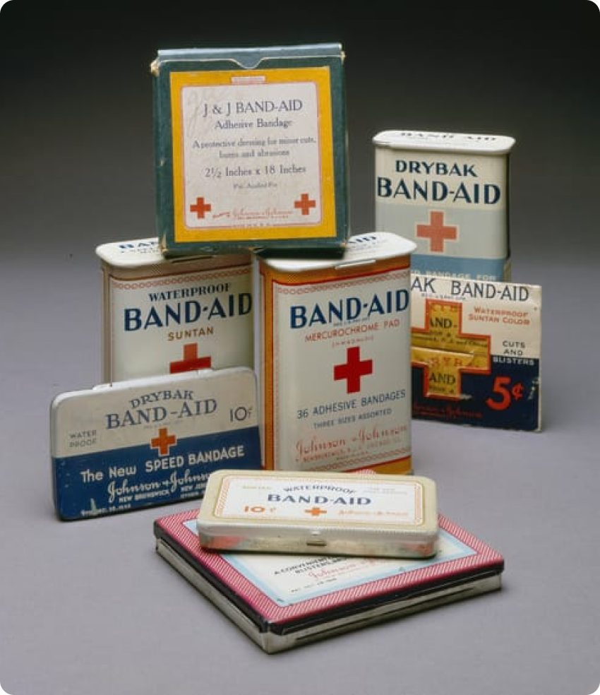 Various versions of BAND-AID® Brand tin packaging