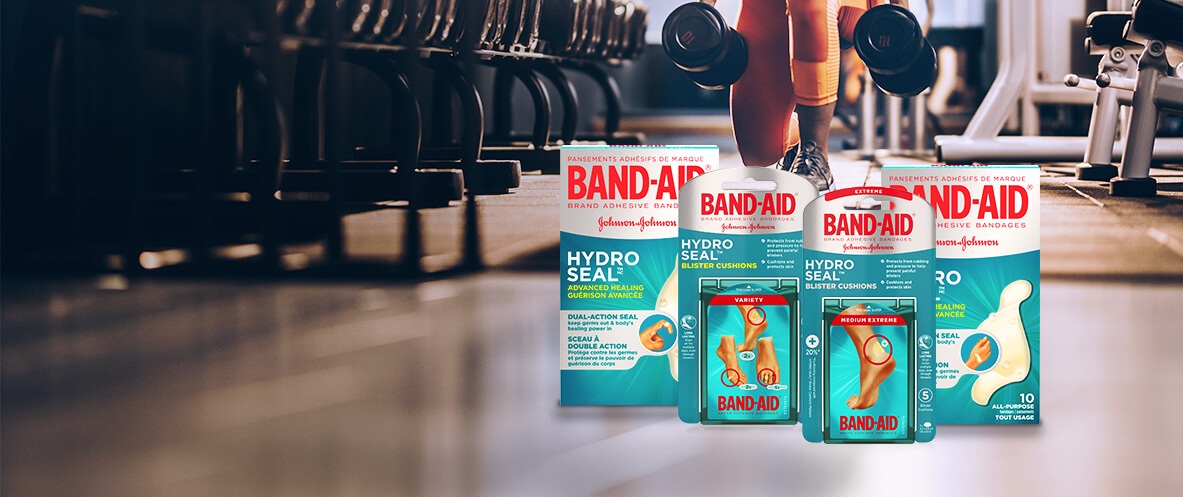 Boxes of HYDRO SEAL gel bandages and blister cushions in front of a person working out