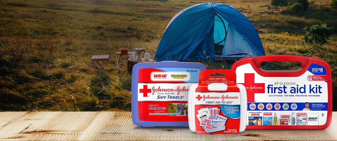 JOHNSON & JOHNSON first aid kits in front of a campsite