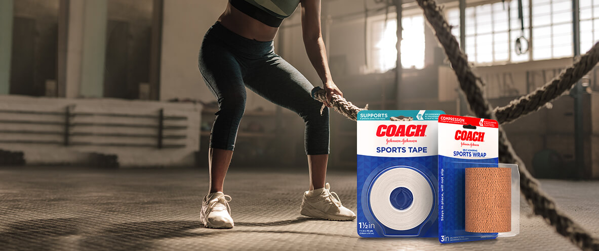 Boxes of JOHNSON & JOHNSON COACH® sports tape and wrap in front of woman working out